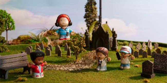 little people figures of the stranger things cast in a model cemetery