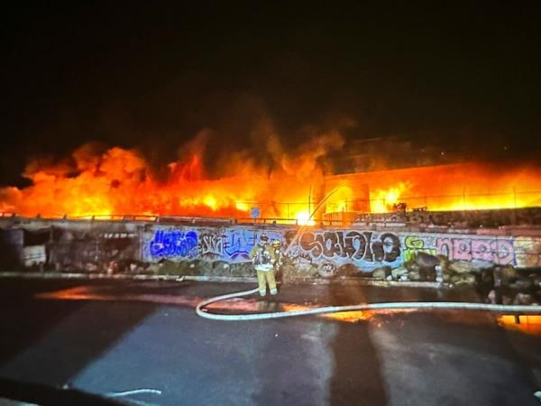 This photo provided by the California Department of Transportation shows an early morning fire along Interstate 10 near downtown Los Angeles, on Nov. 11, 2023. 